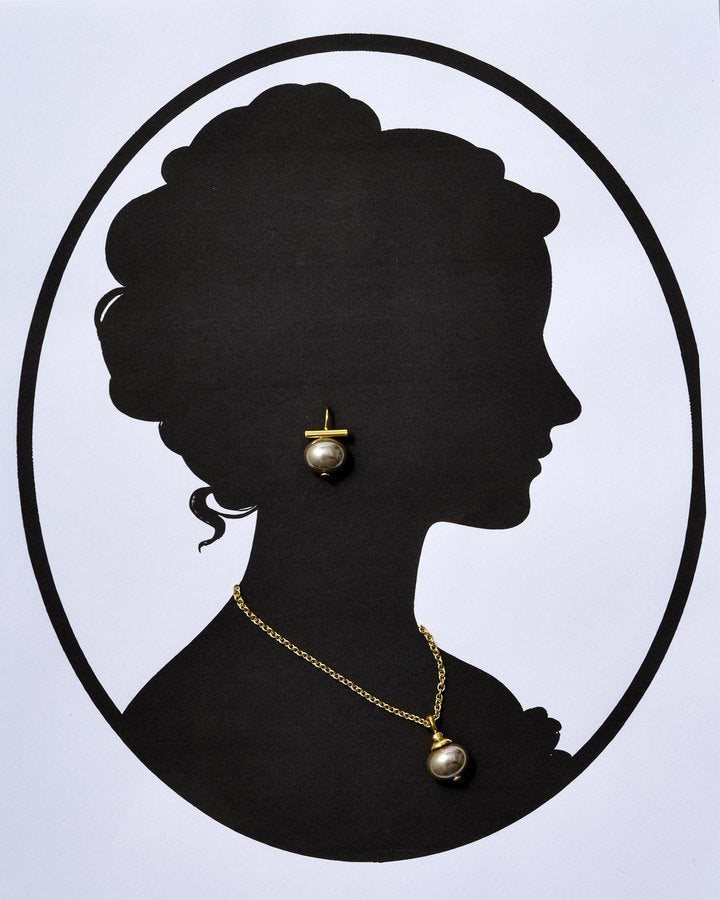 Cameo silhouette with an updo wearing a champagne Pebble Pearl earring and pearl pendant